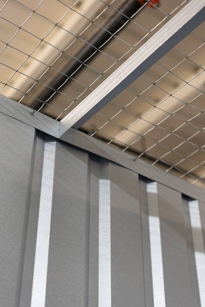 Close-up of Boxwell’s hallway system storage unit featuring durable wire mesh security ceiling and high-quality steel panel construction. Designed to enhance ventilation and security in self-storage facilities while maintaining structural integrity and tenant protection.