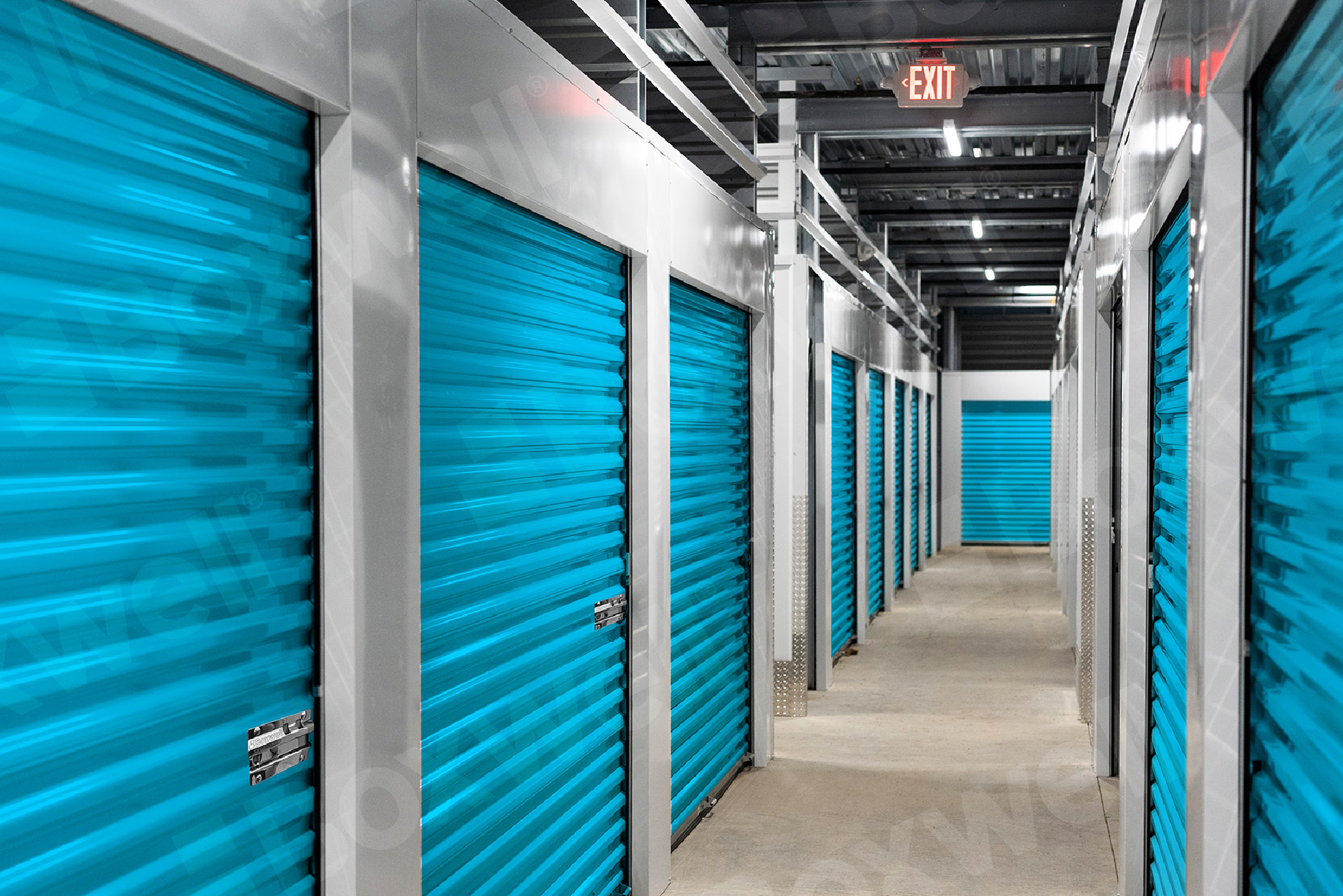 Boxwell indoor hallway storage system with vibrant green roll-up doors, durable steel framing, and customizable unit configurations for modern self-storage facilities.