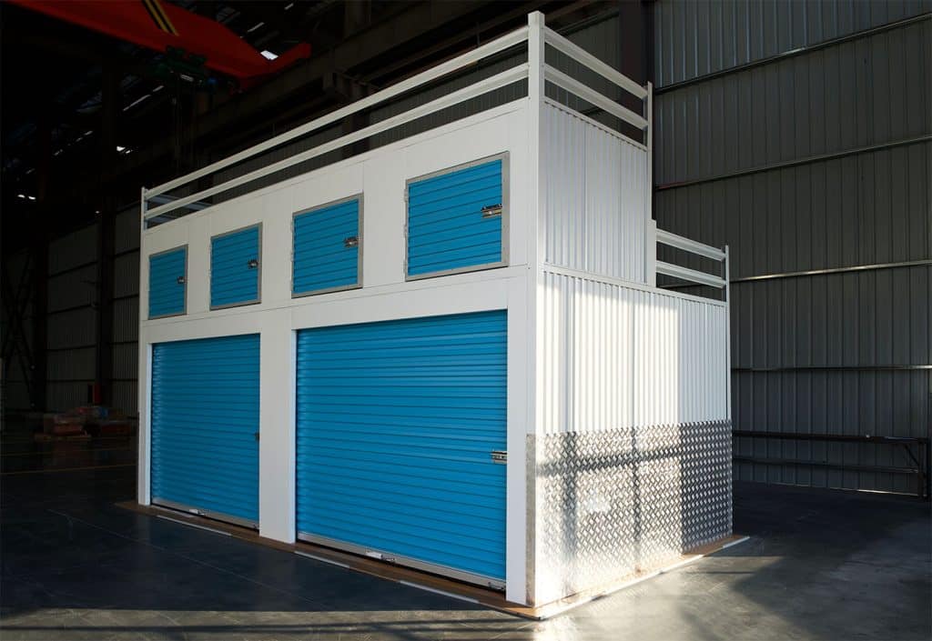 A hallway system with an additional second level. The second level is a locker system with swing doors, and is accessed via staircase.