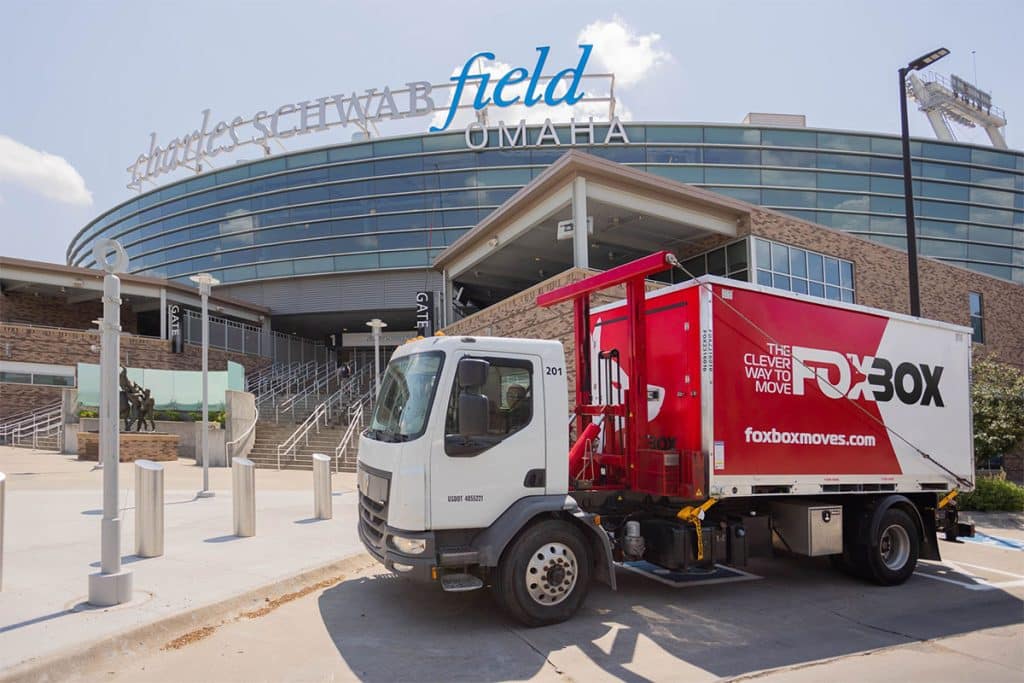 A mobile storage business with a steel storage container parked in front of Charles Schwab Field in Omaha Nebraska.