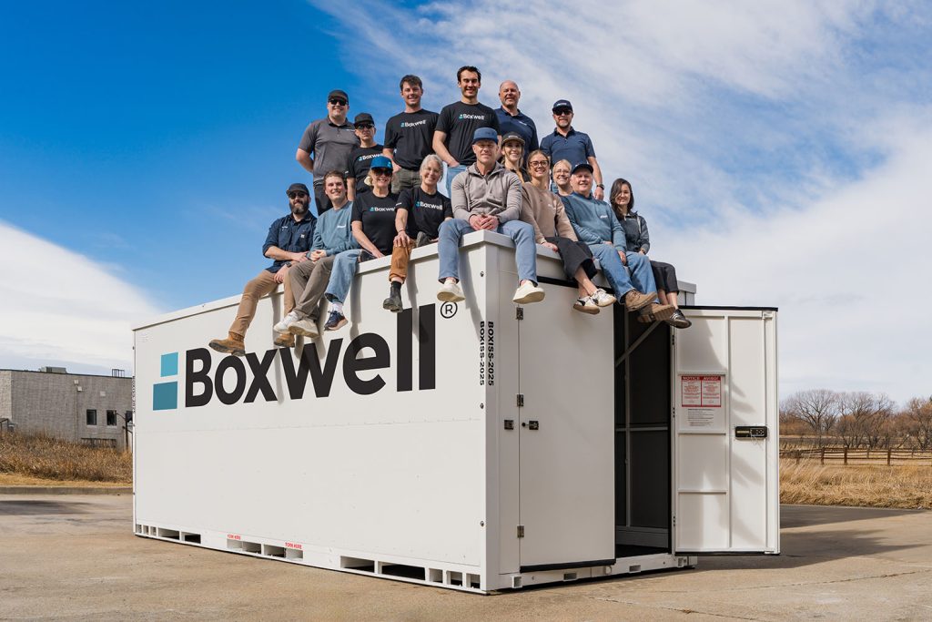 The Boxwell team of employees standing on top of a Boxwell portable storage container. Boxwell is headquartred in Boulder, Colorado. Our portable storage containers, self storage units, hallway systems, and roll up doors are available for purchase worldwide.
